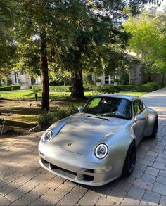 a silver sports car parked in front of a house