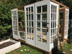 a small shed with windows on top of it