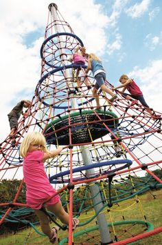 children climbing on the top of a play structure