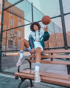 a person sitting on a bench with a basketball