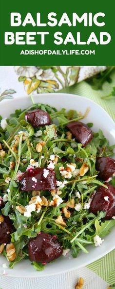 a salad with beets and feta cheese in a white bowl on top of a table