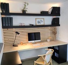 a desk with a computer on top of it