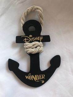 a black anchor with the word wonder hanging from it's side on a white background