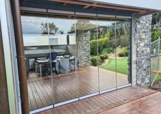 an outdoor patio with sliding glass doors leading to the back yard and dining room area