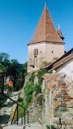 an old building with a steeple on the top and stairs leading up to it