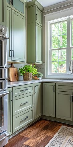 a kitchen with green cabinets and wooden floors