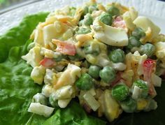 a close up of a plate of food with lettuce and peas on it