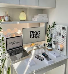 a laptop computer sitting on top of a white desk