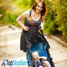 a woman pushing a stroller with a baby in it