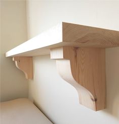 a wooden shelf mounted to the side of a wall