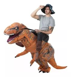 a man riding on the back of an inflatable t - rexe costume