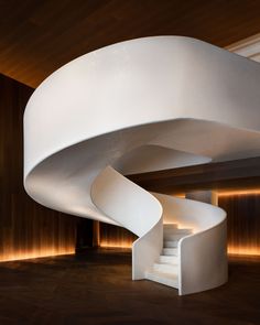 a white spiral staircase in the middle of a room