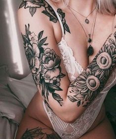 a woman with tattoos on her arm and chest