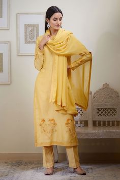 Mustard kurta with embroidered floral motifs on hem and sleeve hems. Comes with pant and sheer dupatta.
Component: 3
Embroidery
Neckine: Round
Sleeve Length: Bracelet
Fabric: Chanderi jacquard, Viscose
Color: Yellow - Aza Fashions Elegant Embroidered Yellow Salwar Kameez, Elegant Yellow Embroidered Salwar Kameez, Embroidered Slub Silk Unstitched Suit With Long Sleeves, Elegant Kurta With Embroidered Border For Festivals, Elegant Art Silk Churidar With Embroidered Border, Embroidered Long Sleeve Slub Silk Unstitched Suit, Elegant Unstitched Suit With Embroidered Border And Long Sleeves, Elegant Yellow Salwar Kameez With Floral Embroidery, Elegant Embroidered Art Silk Kurta