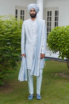 Blue sherwani with resham, dabka embroidery in floral motifs. Paired with kurta, trouser, embroidered border stole and turban.
Component: 5
Pattern: Embroidered
Type Of Work: Resham, Dabka, Glass beads
Neckline: Mandarin
Sleeve Type: Full
Fabric: Raw Silk
Color: Blue
Other Details: 
Weight (in kg): 1.5
Floral motifs
Occasion: Wedding - Aza Fashions Blue Sherwani, Embroidered Sherwani, Sherwani Groom, Vacuum Storage, Indian Man, Fashion App, Custom Tailoring, Embroidered Silk, Raw Silk