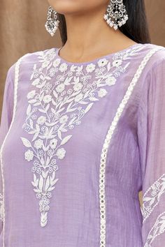 Lilac mulmul chanderi kurta with white thread embroidery, mirror work embellishment and side slits. Paired with a cotton embroidered Pakistani salwar, lehriya crinkled dupatta and sleeveless slip.
Component: 4
Pattern: Embellishment and Embroidered
Type Of Work: Mirror and Thread Work
Neckline: Round
Sleeve Type: Three Quarter
Fabric: Kurta: Mulmul Chanderi, Cotton
Color: Purple
Other Details: 
Gota work stripes on dupatta
Pom-Poms tassels on sleeves hem
Tasselled dupatta
Occasion: Puja - Aza Fa Chanderi Kurta Designs, White Thread Embroidery, Embroidery Kurtis, Plain Kurti Designs, Embroidery Kurta, Modern Hand Embroidery Patterns, Embroidery Mirror, Embroidery Boutique, Pakistani Salwar