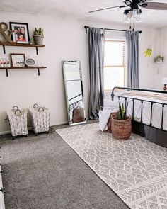 a bed room with a neatly made bed and a mirror