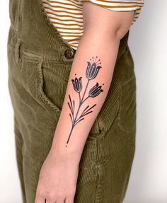 a woman with a flower tattoo on her arm