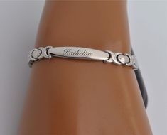 "This engraved ladies' ID heart link bracelet can be personalized on both sides with the engraving of your choice. This personalized bracelet can be custom engraved with names, or any message or instructions. Fits small wrist sizes: 6 inches PLEASE SPECIFY THE DESIRED LENGTH we have extension links Finish: High Polished Stainless Steel Plaque Dimensions: 1.125\" x 0.2\" Our custom engraved stainless steel I.D. bracelets are crafted with High Polish 316L Surgical Stainless Steel; the highest grad Personalized Heart Bracelet, Custom Engraved Bracelet, Medical Bracelet, Engraved Keychain, Jewellery Marketing, Personalized Bracelet, Personalized Bridesmaid Gifts, Engraved Bracelet, Pretty Jewelry