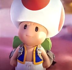 a close up of a toy with a mushroom on it's head and backpack