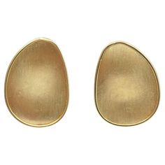 An amazing pair of Marco Bicego 18k gold clip-on earrings. Being crafted from brushed gold, they magnificently reflect the light and look extremely appealing on the ear. Due to its slightly irregular, organic shape the earrings resemble two beautiful gold petals. It's a minimal and chic pair of gold earrings for your daily wear. The earrings are clip-on, the studs can be added. About Marco Bicego's brand Marco Bicego jewelry brings a fresh, unmistakably Italian flair to the ancient art of goldsmithing. Brand’s artisans, true keepers of the Vicenza tradition, creating pieces that spark emotion. This expertise has been handed down like a family secret, from one generation to the next. Rooted in the rich history of Italian jewelry, Marco Bicego has defined a unique style of refined luxury tha Marco Bicego Jewelry, Marco Bicego, Gold Clips, Italian Jewelry, Fine Jewellery Earrings, Organic Shapes, Ancient Art, Clip On Earrings, Gold Earrings