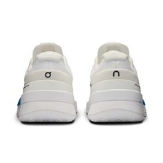 a pair of white sneakers with blue detailing on the soles and bottom part of the shoe