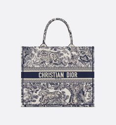 Introduced by Maria Grazia Chiuri, Creative Director of Christian Dior, the Dior Book Tote has become a staple of the Dior aesthetic. Designed to hold all the daily essentials, the style is fully embroidered with the ecru and blue Toile de Jouy motif. Adorned with the Christian Dior Paris signature on the front, the large tote exemplifies the House's savoir-faire and may be carried by hand or worn over the shoulder.. Bracelet Dior, Christian Dior Logo, Dior Aesthetic, Dior Book, Christian Dior Paris, Blue Toile, Book Tote Bag, Womens Designer Bags, Dior Logo