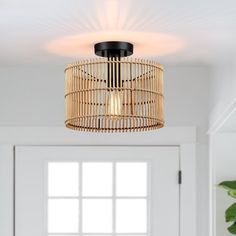 a light that is hanging from the ceiling in a room with white walls and flooring