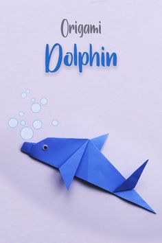 an origami dolphin with bubbles coming out of it's mouth and the word dolphin written in blue