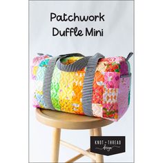 a colorful patchwork duffle bag sitting on top of a wooden stool