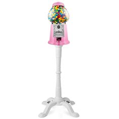 a pink gummy machine on top of a white stand with lots of balls in it