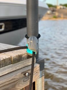 a boat is docked at the dock by the water's edge with a rope attached to it