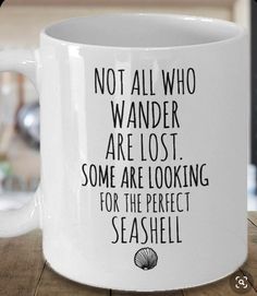 a white coffee mug with the words not all who wander are lost some are looking for the perfect seashell