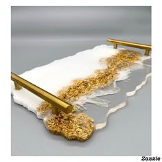 gold and white acrylic art piece with metal handles