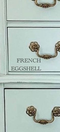 two white drawers with gold handles on each drawer and the words french eggshell above them