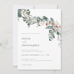 a white wedding card with greenery and red berries