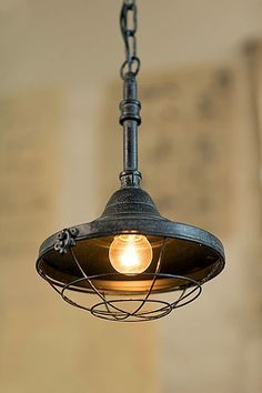 an old fashioned light hanging from a chain