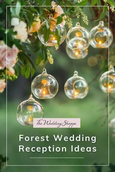 the words forest wedding reception ideas hanging from a tree with clear glass ornaments and flowers