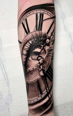 a tattoo with an eye and clock on the arm that is covered in black ink