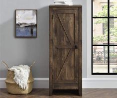 a tall wooden cabinet sitting on top of a hard wood floor next to a window