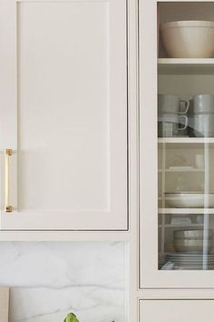 The question of which is the best white paint for kitchen cabinets is an age-old debate, so we asked designers to share their favorite swatches. Off White Paint Colors For Cabinets, White Down Cabinets, Soft Beige Cabinets, Cabinet Colors With Carrara Marble, Sherwin Williams Dover White Kitchen Cabinets, Framed Cabinets Kitchen, Oxford Cream Paint, Cream Kitchen Cabinet Paint Colors, Best Warm White Cabinet Color