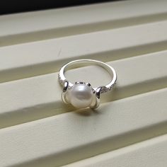 🤍 Gorgeous looking!! Freeform Style Cultured Pearl Ring. Metal: 925 Sterling Silver. Stones: Cultured Pearl, CZ Ring Size: Can be selected Stone Size: 8 mm Total Weight: 2.6 grams Anti-tarnishing coated 🤍  Add a touch of elegance to your jewelry collection with this stunning pearl ring. Crafted from 925 sterling silver, this ring features a cultured off white pearl stone accentuated with sparkling cubic zirconia. The round shape of the pearl and cubic zirconia its excellent cut grade make it a Hallmarked Sterling Silver Pearl Ring For Anniversary, Sterling Silver Open Pearl Ring Fine Jewelry, Sterling Silver Open Pearl Ring, White Gold Sterling Silver Open Pearl Ring, Sterling Silver Hallmarked Pearl Ring For Promise, Silver Hallmarked Pearl Ring For Wedding, Sterling Silver Hallmarked Pearl Promise Ring, Sterling Silver Pearl Drop Ring For Promise, Elegant White Pearl Ring Stamped 925