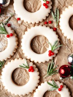 christmas cookies decorated with white icing and red berries