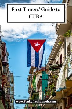 a flag hanging from the side of a building with text overlay that reads first timer's guide to cuba