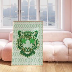 a poster with a tiger's head on it in front of a couch and window