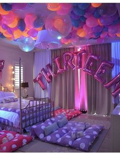 a bedroom decorated with balloons and bedding