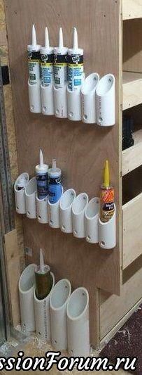 there are many cups on the wall with toothbrushes and glues in them