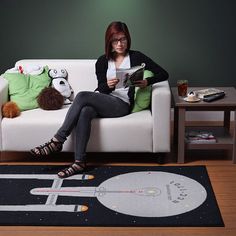 a woman sitting on a couch reading a book