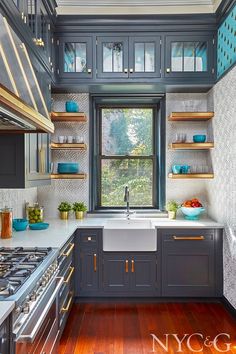 a kitchen with wooden floors and blue cabinets