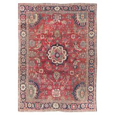 an antique persian rug with red and blue colors